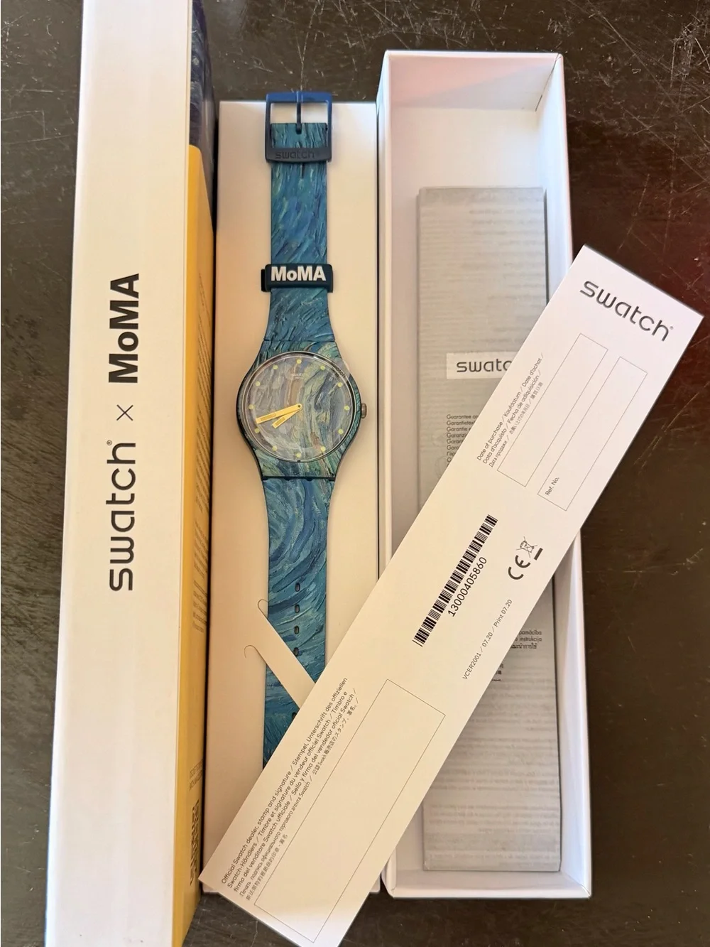 Swatch blue marbled dial and strap watch with yellow hands